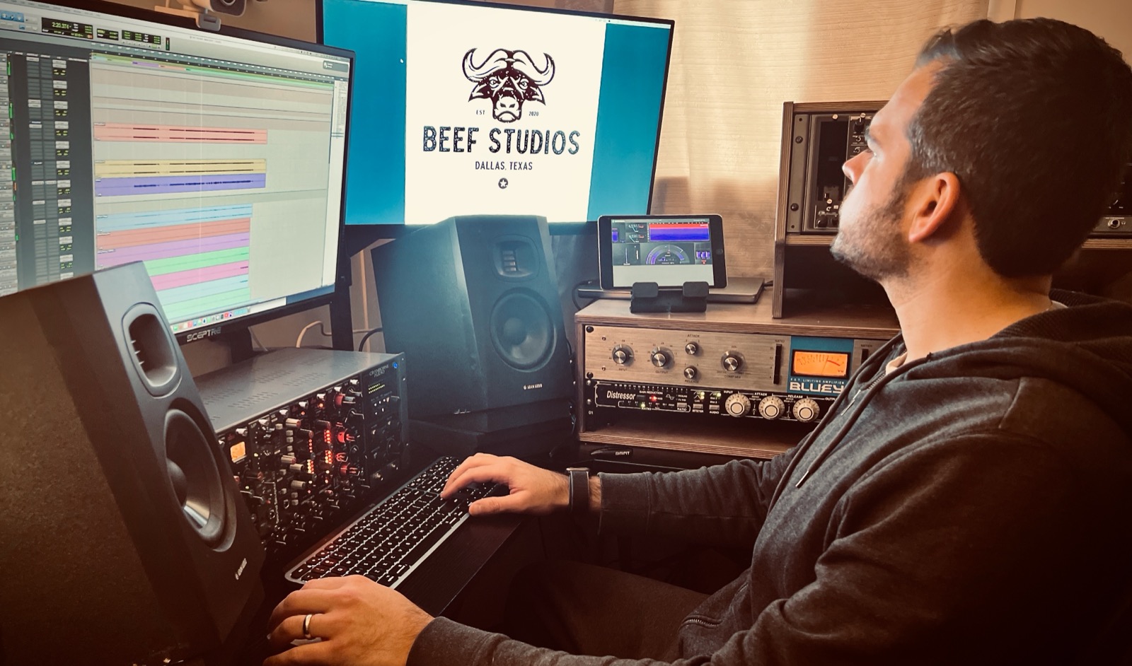 Tal Spirer at the Beef Studios console with monitors, outboard, and the studio brand on screen.